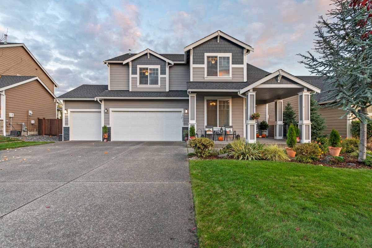 Suburban home with a wide concrete driveway and front walkway